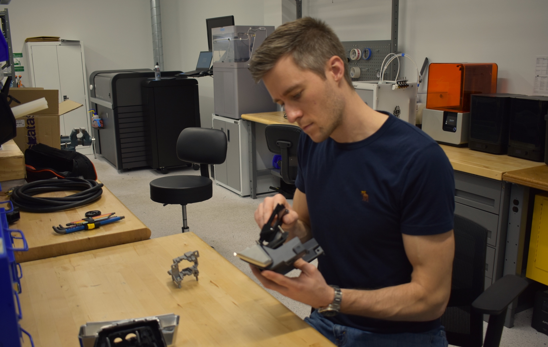 Motional engineer Nikola Hrgic at his workbench adjusts a piece of hardware